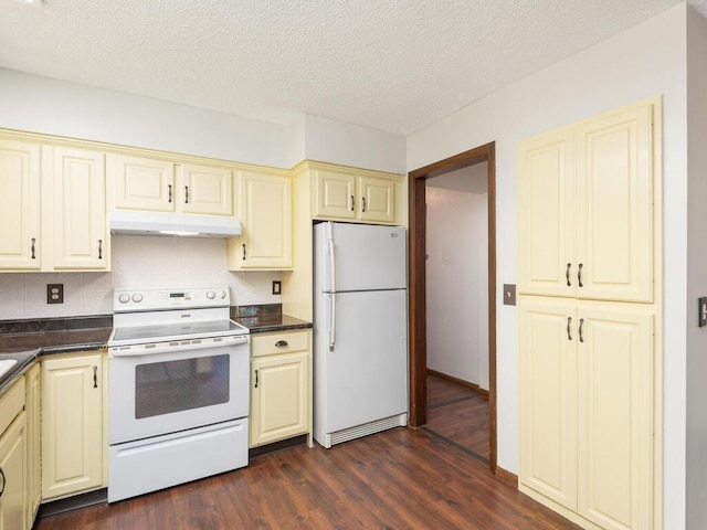 2200 Nevada Ave S Unit 206, Saint Louis Park, MN 55426 - kitchen with white appliances, cream cabinets, under cabinet range hood, dark countertops, and a textured ceiling
