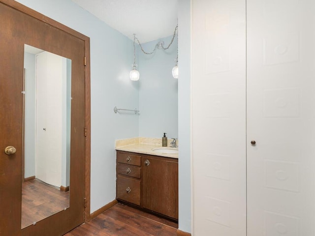 2200 Nevada Ave S Unit 206, Saint Louis Park, MN 55426 - bathroom with wood finished floors, vanity, and baseboards