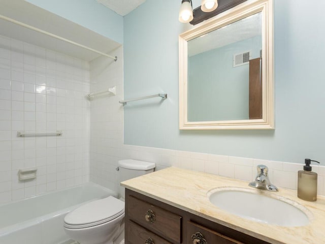 2200 Nevada Ave S Unit 206, Saint Louis Park, MN 55426 - bathroom featuring vanity, toilet, shower / tub combination, and tile walls