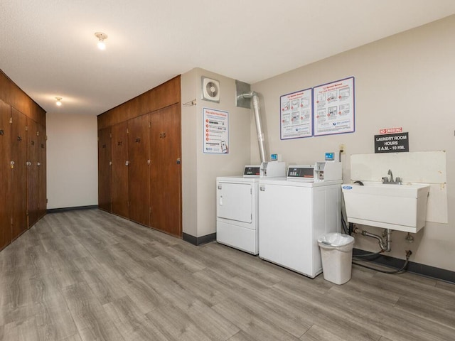 2200 Nevada Ave S Unit 206, Saint Louis Park, MN 55426 - shared laundry room featuring light wood-style flooring, washer and clothes dryer, and baseboards