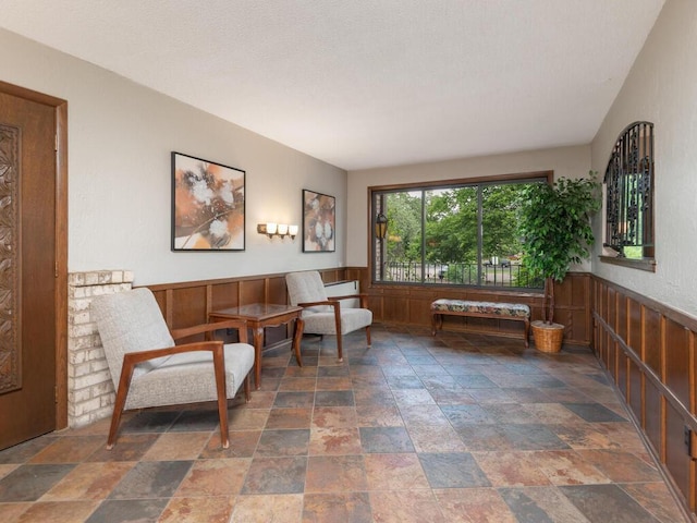 2200 Nevada Ave S Unit 206, Saint Louis Park, MN 55426 - living area with stone finish floors, wainscoting, and wooden walls