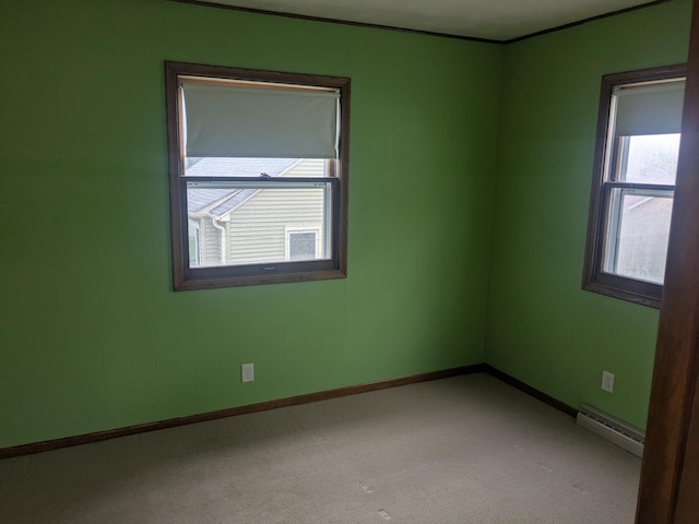 1193 County Road B E, Maplewood, MN 55109 - empty room with baseboard heating, healthy amount of natural light, and carpet