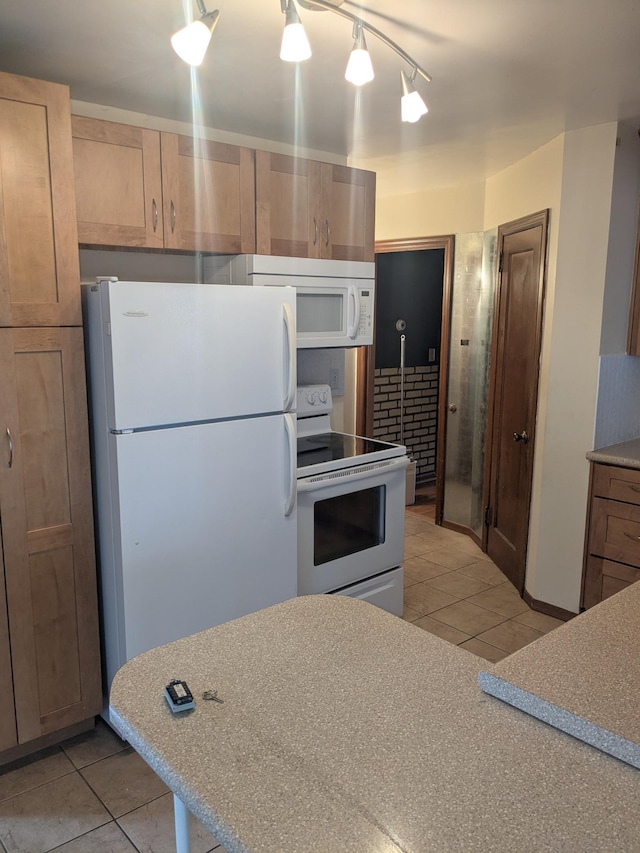 1193 County Road B E, Maplewood, MN 55109 - kitchen with white appliances and light tile patterned flooring
