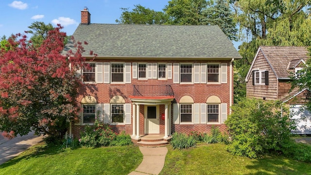1913 River Pkwy, Minneapolis, MN 55414 - view of front of property featuring brick siding, a chimney, a front lawn, and roof with shingles