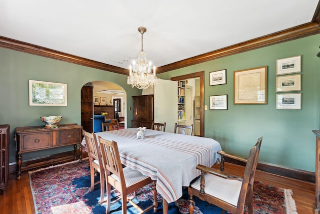 1913 River Pkwy, Minneapolis, MN 55414 - dining room featuring arched walkways, ornamental molding, a chandelier, and wood finished floors