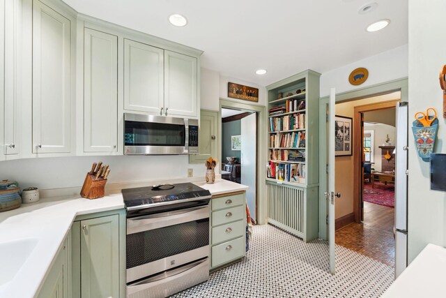 1913 River Pkwy, Minneapolis, MN 55414 - kitchen with appliances with stainless steel finishes, green cabinets, light countertops, and recessed lighting