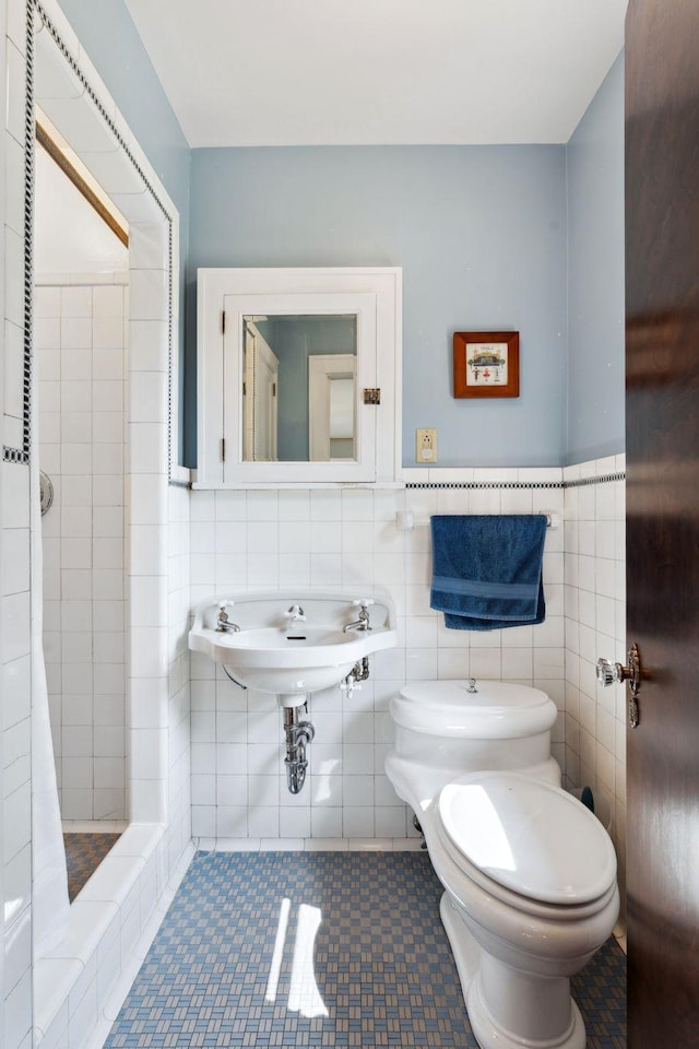 1913 River Pkwy, Minneapolis, MN 55414 - bathroom with tile walls, a tile shower, and wainscoting