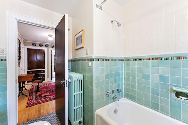 1913 River Pkwy, Minneapolis, MN 55414 - bathroom with radiator, wood finished floors, and tile walls