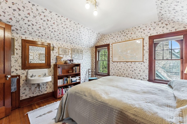 1913 River Pkwy, Minneapolis, MN 55414 - bedroom featuring wallpapered walls, hardwood / wood-style flooring, and multiple windows