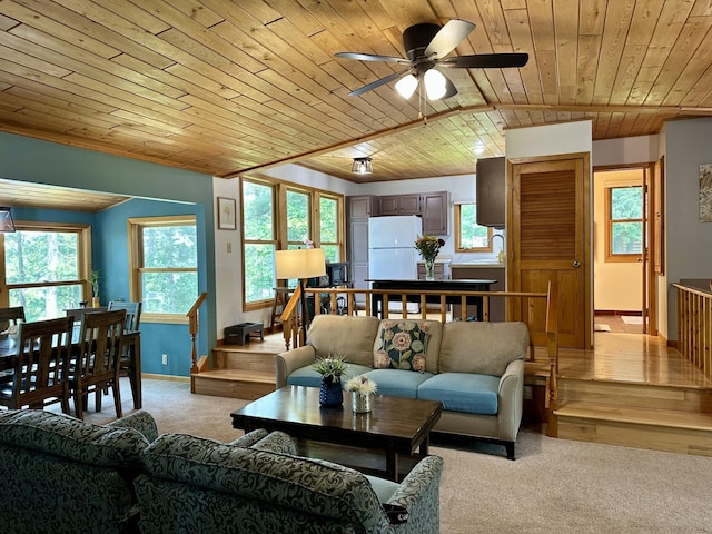 12332 Manhattan Point Blvd, Crosslake, MN 56442 - living room featuring wooden ceiling, light colored carpet, a ceiling fan, and plenty of natural light
