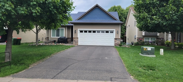 12383 Midway Cir NE, Blaine, MN 55449 - view of front of property featuring an attached garage, driveway, a front lawn, stone siding, and a shingled roof