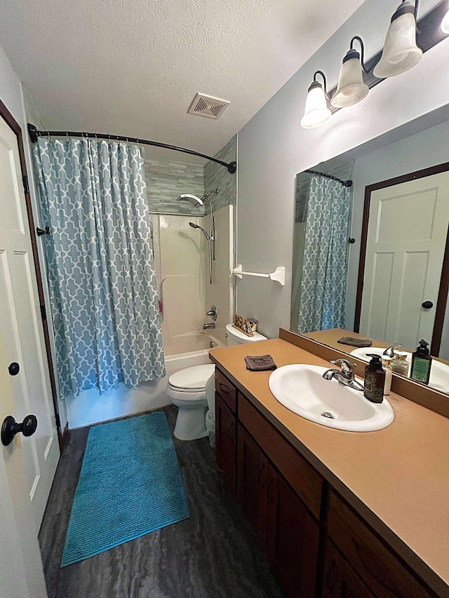 12383 Midway Cir NE, Blaine, MN 55449 - full bath featuring vanity, shower / tub combo, a textured ceiling, and wood finished floors