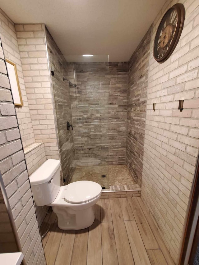 12383 Midway Cir NE, Blaine, MN 55449 - full bathroom with tiled shower and wood finished floors