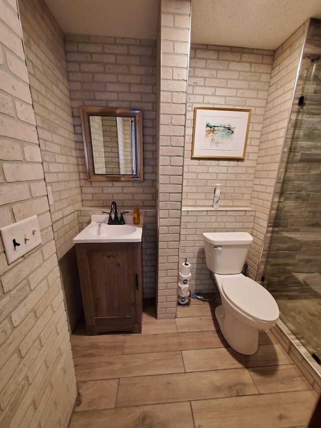 12383 Midway Cir NE, Blaine, MN 55449 - full bath featuring vanity, a stall shower, wood finished floors, and brick wall