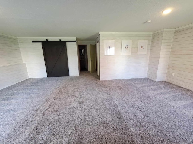 12383 Midway Cir NE, Blaine, MN 55449 - unfurnished bedroom featuring carpet flooring, a barn door, and crown molding
