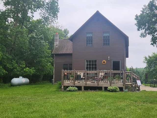 23064 Pearl Lake Rd, Lake View Twp, MN 56501 - back of house featuring a wooden deck, a lawn, and a chimney