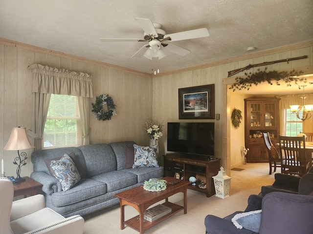 23064 Pearl Lake Rd, Lake View Twp, MN 56501 - living room with wooden walls, a chandelier, healthy amount of natural light, a ceiling fan, and a textured ceiling