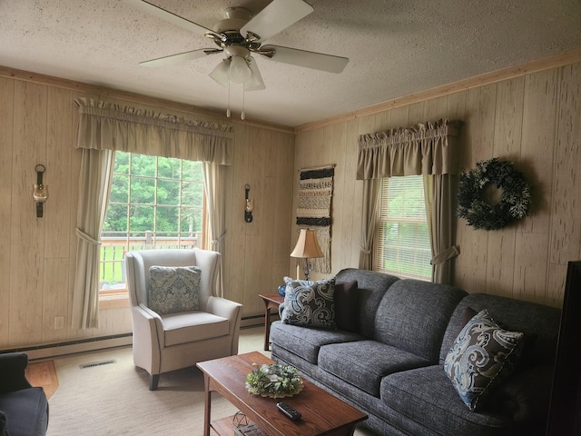 23064 Pearl Lake Rd, Lake View Twp, MN 56501 - living room featuring wooden walls, a textured ceiling, ceiling fan, and a baseboard radiator