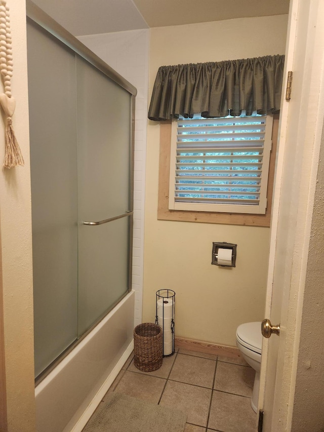 23064 Pearl Lake Rd, Lake View Twp, MN 56501 - bathroom featuring tile patterned floors, toilet, shower / bath combination with glass door, and baseboards