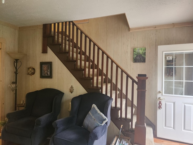 23064 Pearl Lake Rd, Lake View Twp, MN 56501 - stairs with wood walls and a textured ceiling