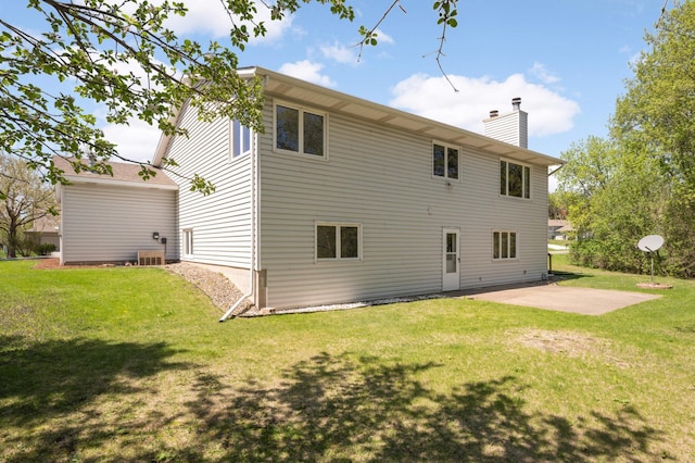 3924 Denmark Ave, Eagan, MN 55123 - rear view of house featuring a chimney, a yard, and a patio