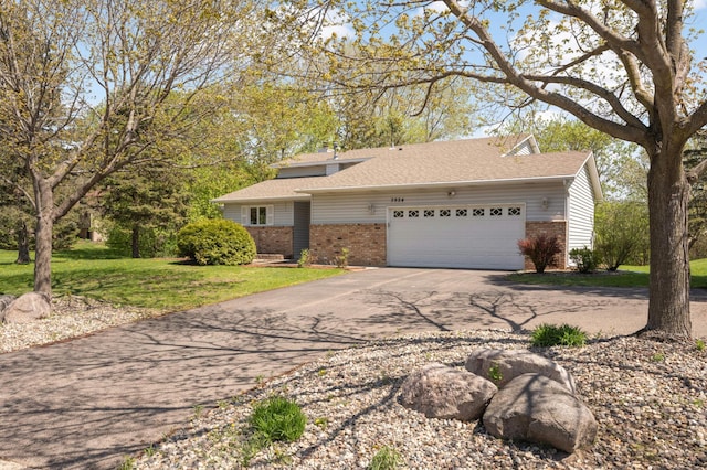 3924 Denmark Ave, Eagan, MN 55123 - view of front of house with brick siding, driveway, an attached garage, and a front lawn