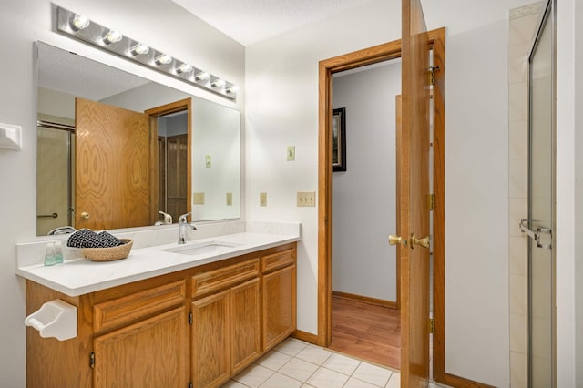 3924 Denmark Ave, Eagan, MN 55123 - full bathroom featuring vanity, tile patterned flooring, and a shower with shower door