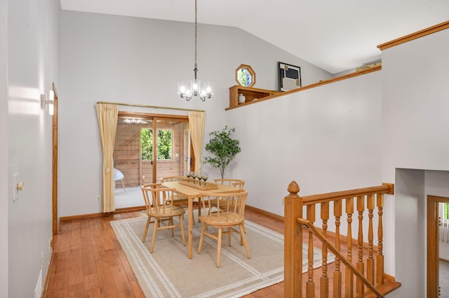 3924 Denmark Ave, Eagan, MN 55123 - dining room featuring a chandelier, wood-type flooring, high vaulted ceiling, and baseboards