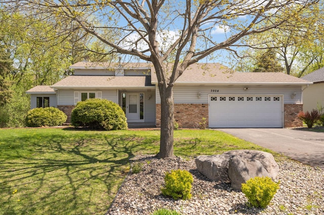 3924 Denmark Ave, Eagan, MN 55123 - view of front of house with brick siding, a garage, a front yard, and asphalt driveway
