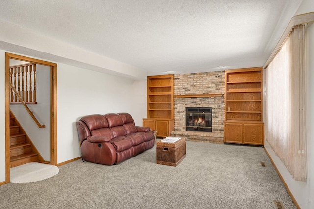 3924 Denmark Ave, Eagan, MN 55123 - carpeted living area featuring a brick fireplace, a textured ceiling, stairway, baseboards, and built in features