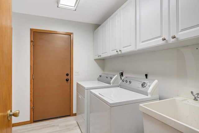 3924 Denmark Ave, Eagan, MN 55123 - laundry room with cabinet space, washing machine and dryer, and light wood-type flooring