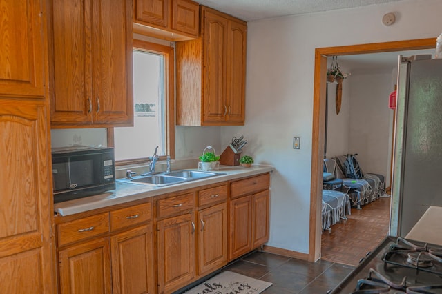 2161 Ross Ave E, Saint Paul, MN 55119 - kitchen featuring black microwave, light countertops, and brown cabinetry