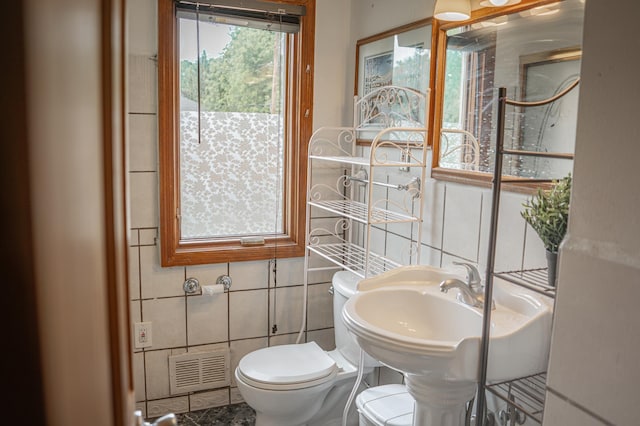 2161 Ross Ave E, Saint Paul, MN 55119 - bathroom with toilet and tile walls
