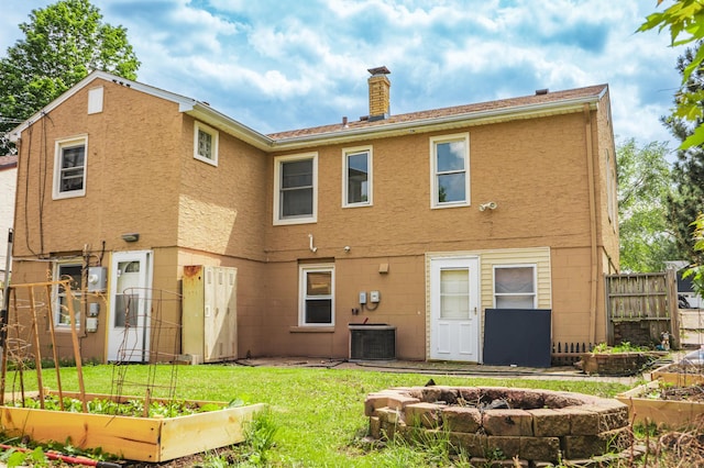 2161 Ross Ave E, Saint Paul, MN 55119 - rear view of house featuring a garden, a chimney, and an outdoor fire pit