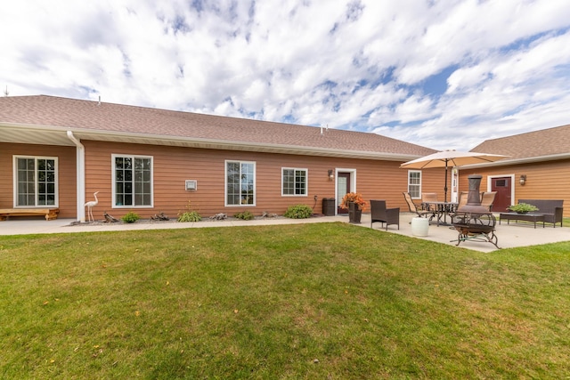 1614 8th St, Grand Rapids, MN 55744 - rear view of property featuring a patio, a lawn, and central AC