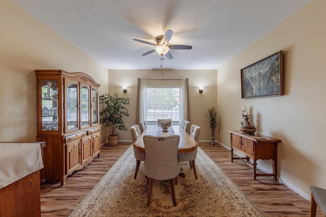 1614 8th St, Grand Rapids, MN 55744 - dining area featuring a ceiling fan, light wood-style floors, baseboards, and a textured ceiling