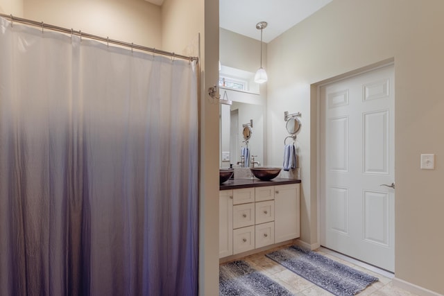 1614 8th St, Grand Rapids, MN 55744 - full bathroom with vanity, tile patterned flooring, a shower with curtain, and baseboards