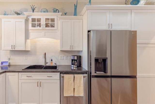 1614 8th St, Grand Rapids, MN 55744 - kitchen with appliances with stainless steel finishes, tasteful backsplash, white cabinets, and glass insert cabinets