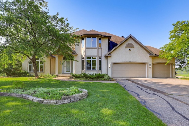 18715 24th Ave N, Plymouth, MN 55447 - view of front of property featuring asphalt driveway, stucco siding, an attached garage, and a front yard