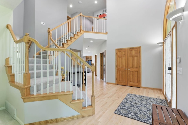 18715 24th Ave N, Plymouth, MN 55447 - entryway featuring a towering ceiling, wood finished floors, baseboards, stairs, and recessed lighting