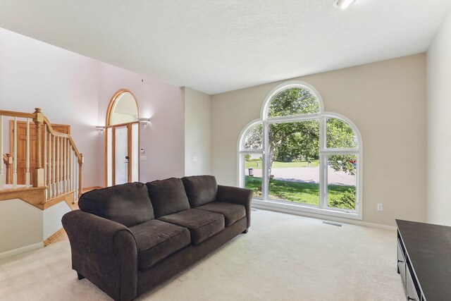 18715 24th Ave N, Plymouth, MN 55447 - living room featuring light carpet, baseboards, and stairs