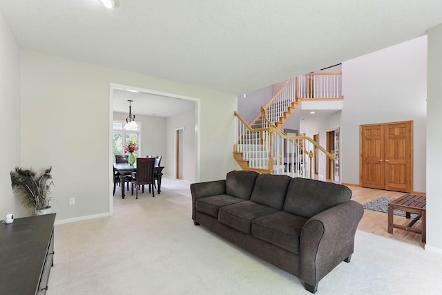18715 24th Ave N, Plymouth, MN 55447 - living room with stairway, light carpet, baseboards, and a chandelier