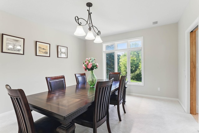 18715 24th Ave N, Plymouth, MN 55447 - dining space with light colored carpet, baseboards, and a chandelier