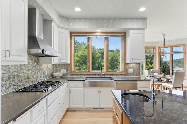 18715 24th Ave N, Plymouth, MN 55447 - kitchen with wall chimney range hood, a sink, stainless steel appliances, white cabinetry, and recessed lighting