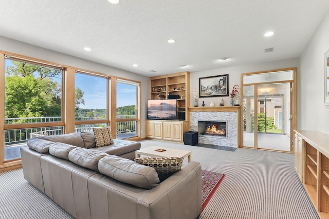 18715 24th Ave N, Plymouth, MN 55447 - carpeted living room with recessed lighting, a stone fireplace, and built in shelves