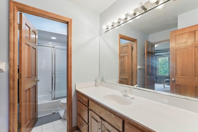 18715 24th Ave N, Plymouth, MN 55447 - bathroom featuring vanity, toilet, tile patterned floors, and shower / bath combination with glass door