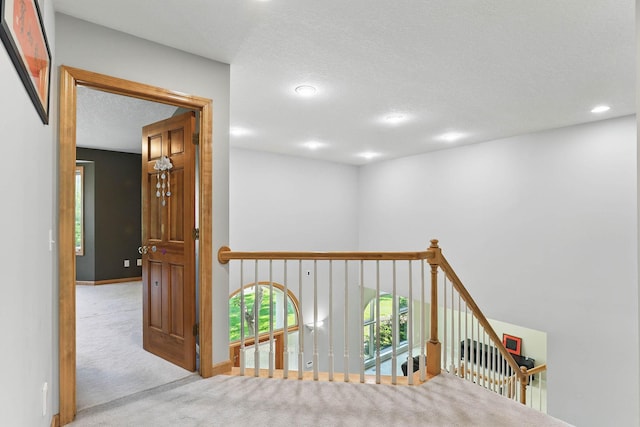 18715 24th Ave N, Plymouth, MN 55447 - corridor featuring carpet floors, an upstairs landing, recessed lighting, a textured ceiling, and baseboards