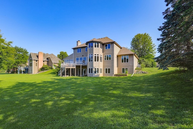 18715 24th Ave N, Plymouth, MN 55447 - back of house with a chimney, a lawn, and a wooden deck