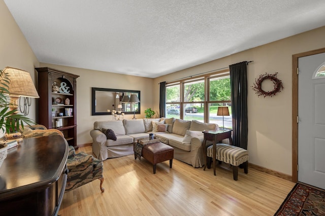 9452 Stevens Ave S, Bloomington, MN 55420 - living area with light wood-type flooring, baseboards, and a textured ceiling