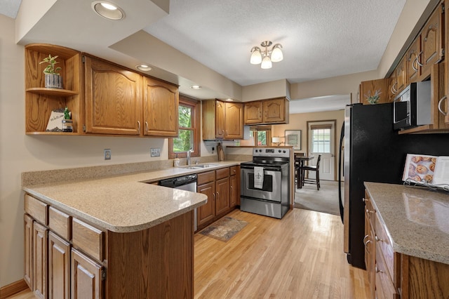 9452 Stevens Ave S, Bloomington, MN 55420 - kitchen featuring appliances with stainless steel finishes, a peninsula, a sink, brown cabinetry, and light countertops